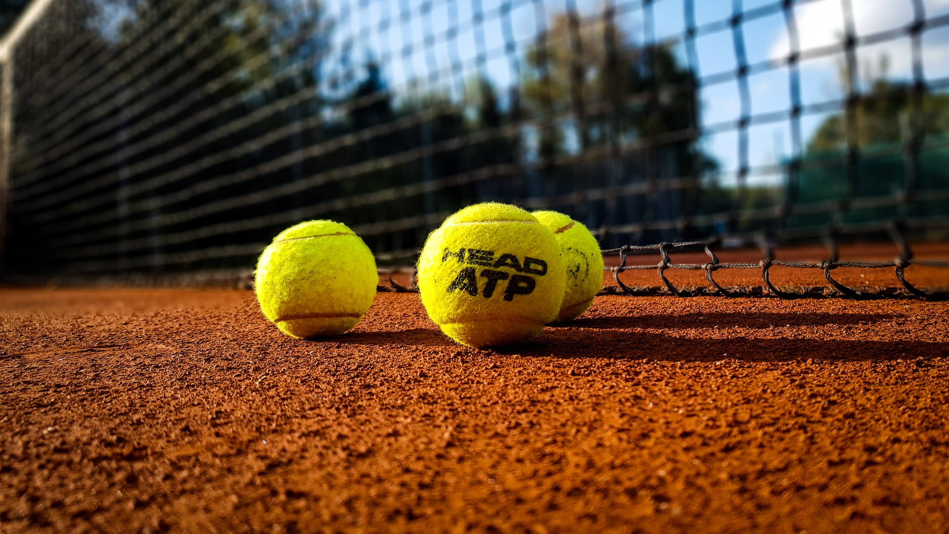 yellow tennis ball on brown sand